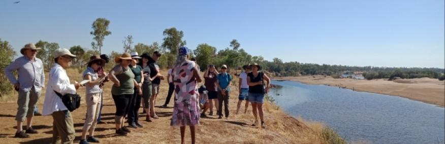 Group of people standing beside a riverbed